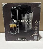 Front of retail box showing DeLonghi Nespresso Vertuo coffee machine