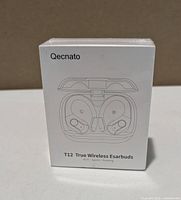 Front of sealed Qecnato T12 earbuds box showing product image and branding