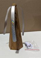 fly repellent fan, blades extended, wood-grain finish, USB port visible