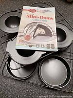 Cover booklet and several pans displayed