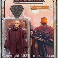 Front of sealed blister card showing Boba Fett figure, cloak and credit accessory