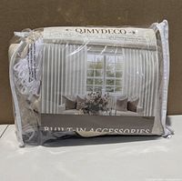 Front of packaged QJMYDECO blackout curtains showing branding and product photo