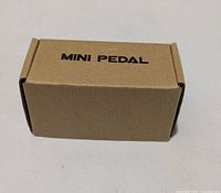 Closed kraft box with MINIPEDAL text
