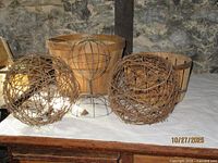 Group view of two grapevine balls, wire sphere form, and both baskets
