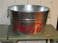 Front view showing Coca-Cola logo and galvanized finish