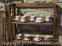 All eight teacup and saucer sets on shelf