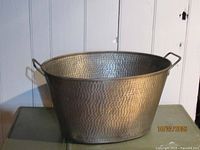 Front view of hammered copper oval tub