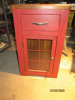 Front view showing drawer, glass door and hardware