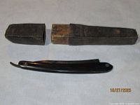 Razor folded beside two-piece case showing wear and interior lining