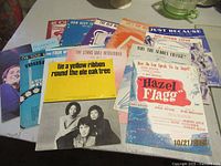 First group of assorted sheet music titles fan-spread on table