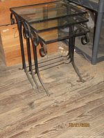 Three wrought iron nesting tables stacked