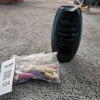 burner standing upright beside bag of cones