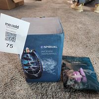 Closed box of Spirual Incense Waterfall next to sealed pouch of Spirual incense cones