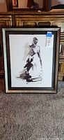 Full view of framed ink figure artwork