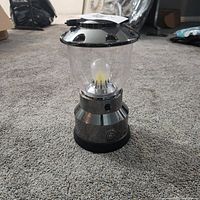 Full view of GE LED lantern on floor, showing overall design and size