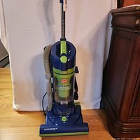 Full view of Hoover Power Max Cyclonic upright vacuum with hose and attachments
