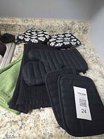 Full lot showing towels, oven mitt and pot holders