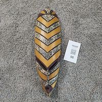 Front view of carved wooden tribal mask showing full design and pattern