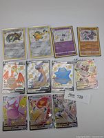 All eleven Pokémon shiny, full art and VMAX cards laid out front side visible