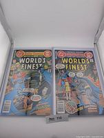 Both World's Finest Comics issues side by side in top loaders