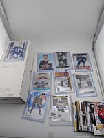 Overall view showing storage box, six toploaded rookie cards, stack of loose cards