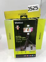 Front of boxed Vivitar selfie stick tripod showing product features and quantity visible