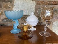 All four glass pieces grouped on table