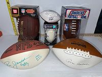 Group shot showing five footballs and Snickers candy bowl