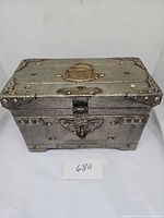 Front angled view of Camelot chest showing latch and rivet details