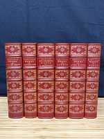 Spines of six matching red leather poetical works volumes