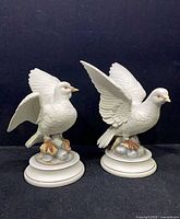Front view of both porcelain dove figurines on bases