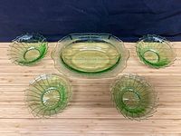 Five uranium glass bowls on table