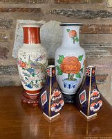 Front view of all four vases showing designs and colours