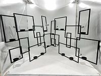 Both candle holder sculptures displayed together to show overall geometric design and number of candle platforms