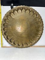 Full view of brass scalloped tray with ruler for scale