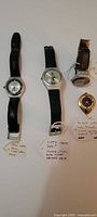 Three Swatch wristwatches and one pendant watch with tags