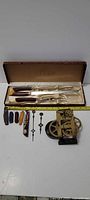 Full lot overview with carving set, pocket knives, clock movement and hands