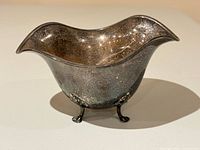 Front view of sterling silver footed bowl on three feet