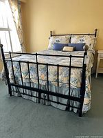 Full bed frame assembled showing headboard, footboard, bedding for scale