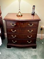 Full view of mahogany four-drawer chest with brass hardware