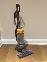 Left-front view of Dyson DC66 upright vacuum showing entire unit