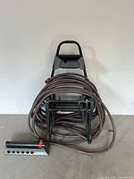 Overall view of hose caddie, hose, sprinkler