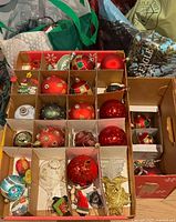 Two divided cardboard trays filled with assorted ornaments