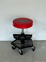 Full view of Motomaster red mechanic stool showing seat, tray, wheels