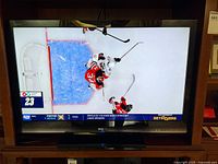 Front view of Sharp Aquos TV powered on