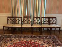 Front view of seven mahogany dining chairs aligned