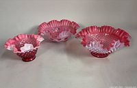 Group shot of all three ruffled cranberry opalescent bowls