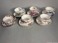 Front view of all six teacup and saucer pairs displayed