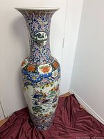 Full view of tall porcelain vase showing proportions and decoration
