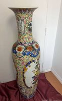 Full view of tall flared-rim porcelain floor vase with multicolour decoration